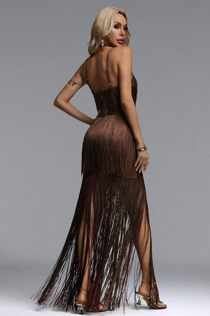 Woman wearing a brown fringe dress on a gray background