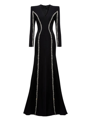 Black evening gown with silver trim on a white background