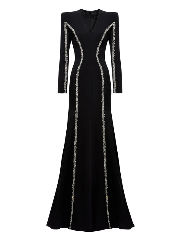 Black evening gown with silver trim on a white background