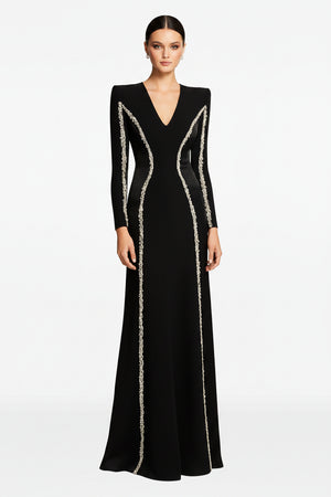 Black evening gown with silver embellishments on a white background