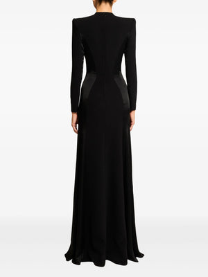 Black evening gown with long sleeves on a white background