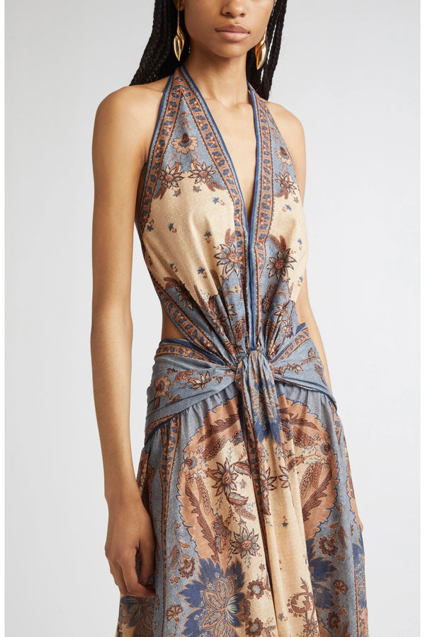 Woman wearing a patterned dress with a plain background