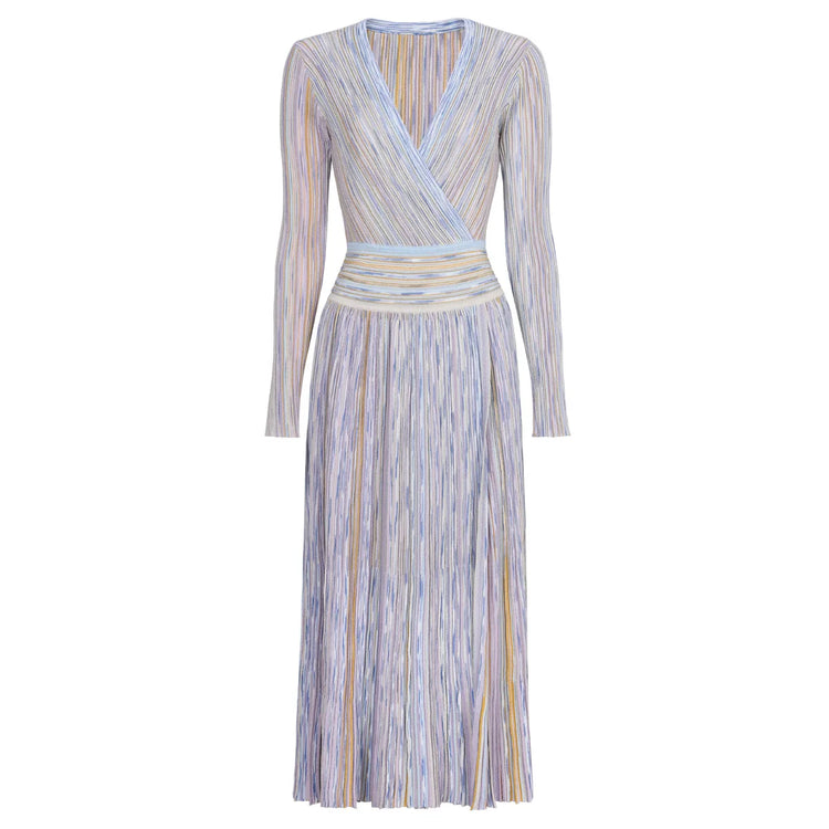 Woman wearing a long-sleeve, striped dress on a white background