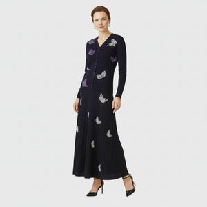 Black dress with purple floral embroidery on a white background