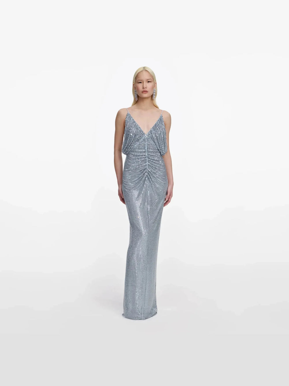 Woman wearing a silver sequin gown on a white background