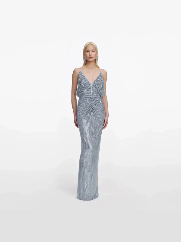 Woman wearing a silver sequin gown on a white background