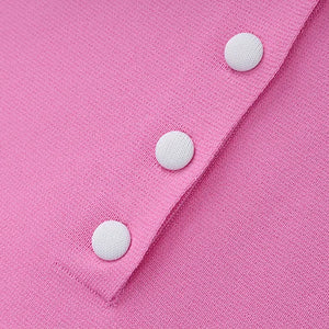 Close-up of a pink fabric with white buttons