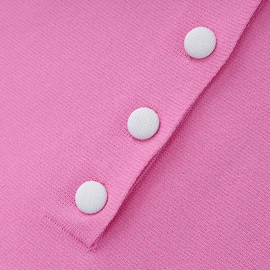 Close-up of a pink fabric with white buttons