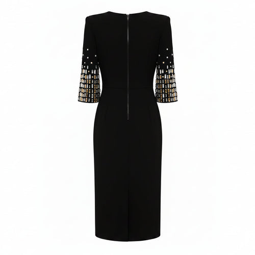 Black dress with embellished sleeves on a white background