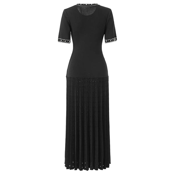 Black dress with studded details on a white background