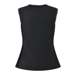 Black sleeveless top with textured trim on a white background