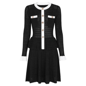 Black dress with white accents and buttons on a white background
