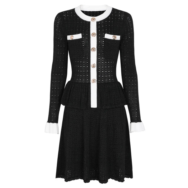 Black dress with white accents and buttons on a white background