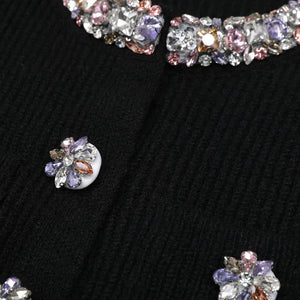 Close-up of sparkling jewelry on a textured black surface