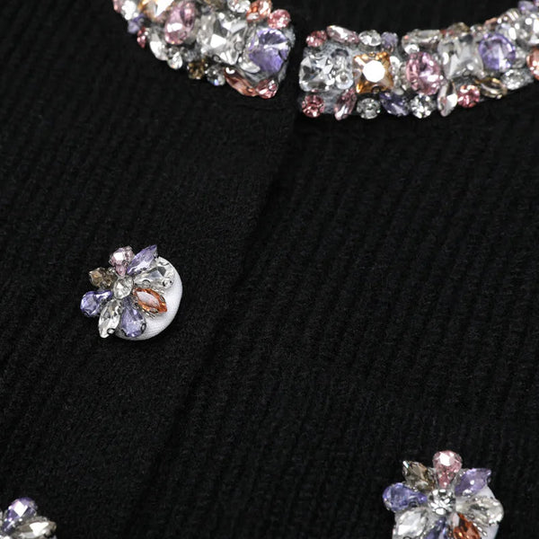 Close-up of sparkling jewelry on a textured black surface