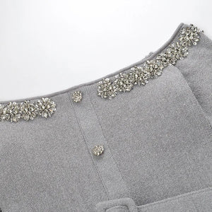 Gray garment with decorative embellishments on a white background