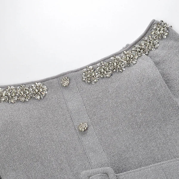 Gray garment with decorative embellishments on a white background