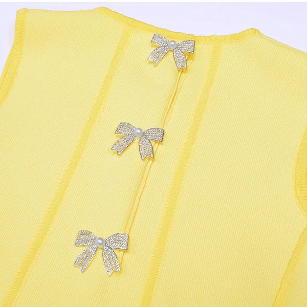 Yellow vest with decorative bows on a light purple background