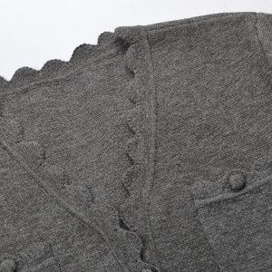Close-up of a gray textured fabric with scalloped edge