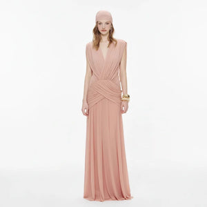 Woman wearing a pink evening gown on a white background