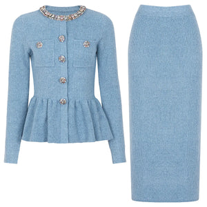 Light blue ribbed sweater with decorative buttons and matching skirt on a white background