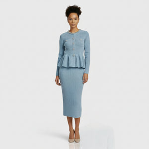 Light blue ribbed sweater with decorative buttons and matching skirt on a white background
