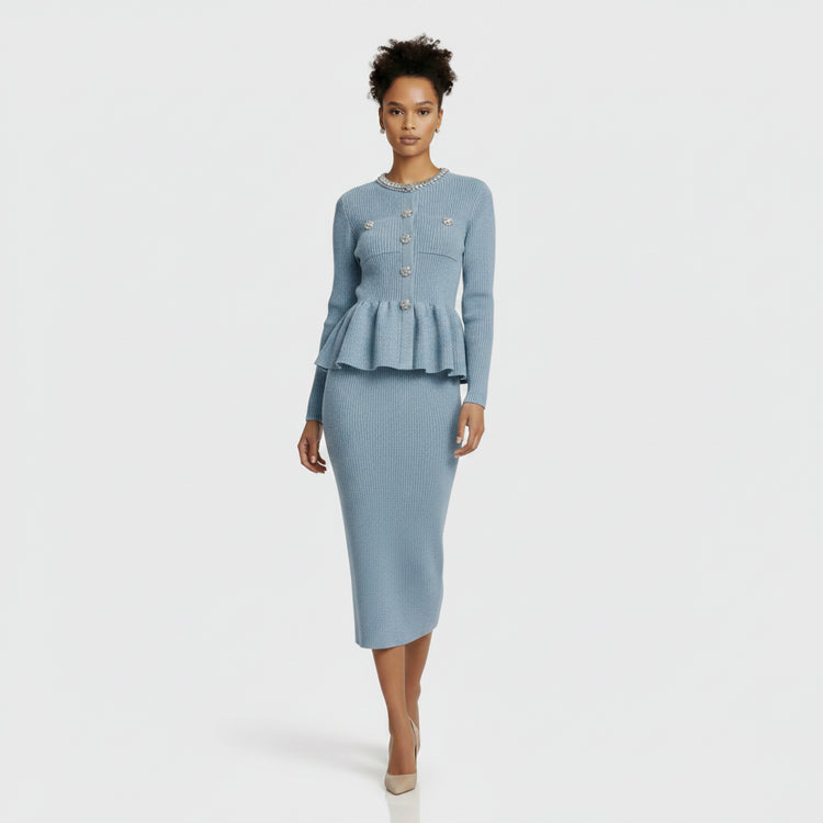Light blue ribbed sweater with decorative buttons and matching skirt on a white background