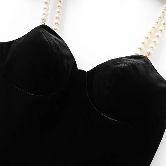 Black strapless top on a mannequin with a white background