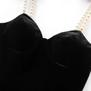 Black strapless top on a mannequin with a white background