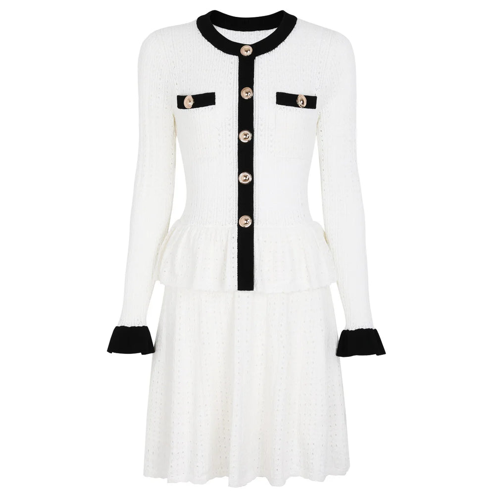 White dress with black accents and buttons on a white background