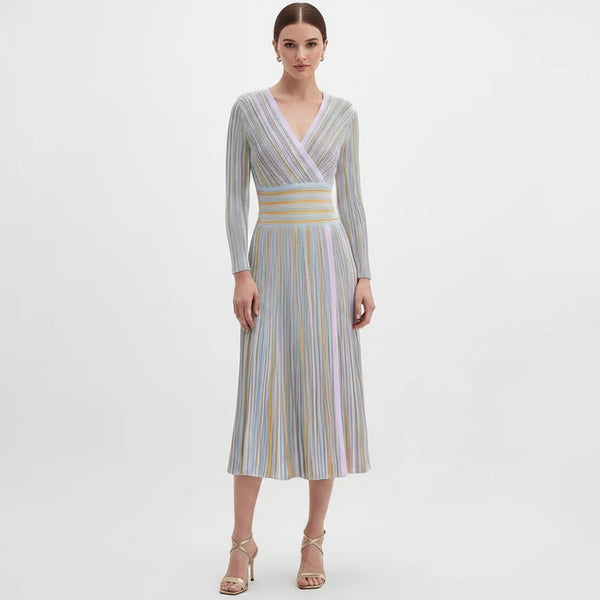 Woman wearing a long-sleeve, striped dress on a white background