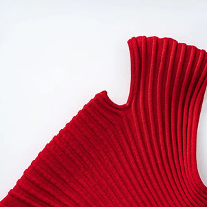 Red ribbed sweater on a wooden hanger against a white background