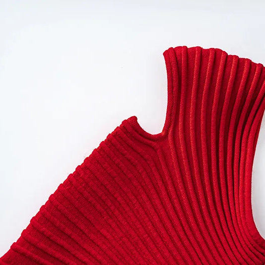 Red ribbed sweater on a wooden hanger against a white background