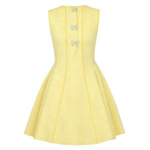 Yellow dress with bow details on a white background