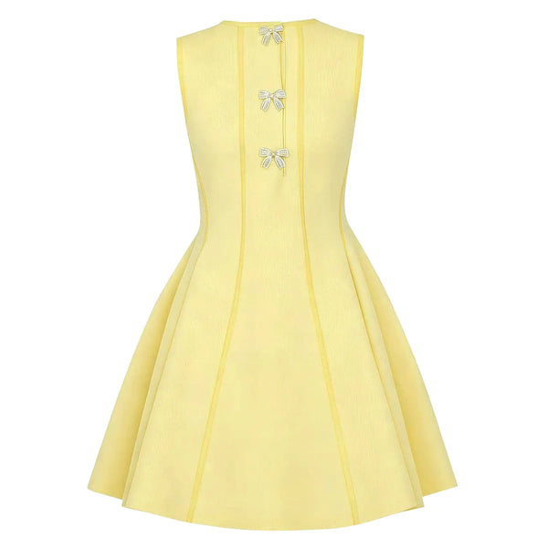 Yellow dress with bow details on a white background