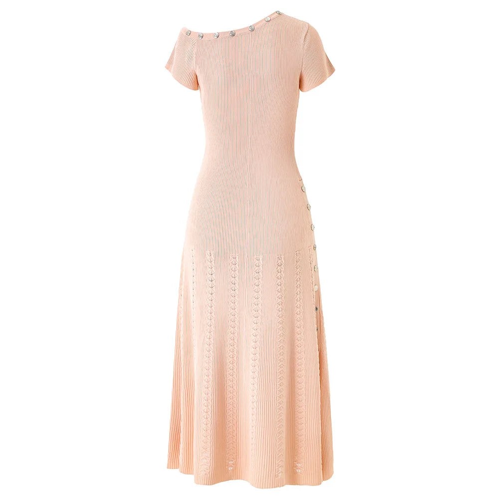 Pink dress with decorative buttons on a white background