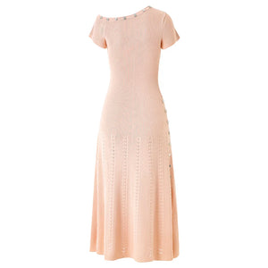 Pink dress with decorative buttons on a white background