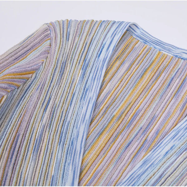 Close-up of a multicolored striped fabric with blue, yellow, and purple hues.