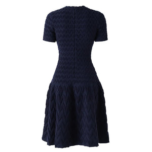 Navy blue dress with a geometric pattern on a white background