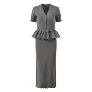 Gray dress with peplum detail on a white background
