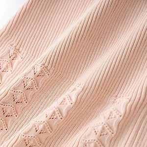 Close-up of pink ribbed fabric with subtle pattern