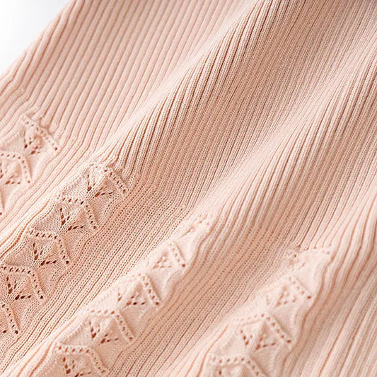 Close-up of pink ribbed fabric with subtle pattern