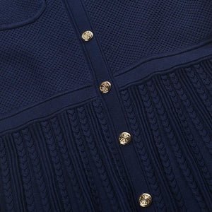 Navy blue textured dress with gold buttons on a white background