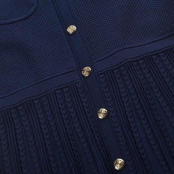 Navy blue textured dress with gold buttons on a white background