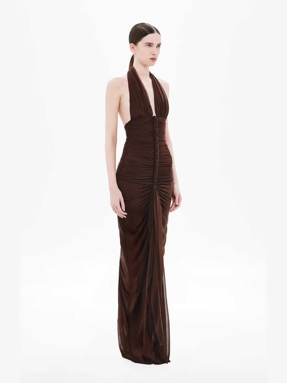 Woman wearing a brown evening gown on a white background