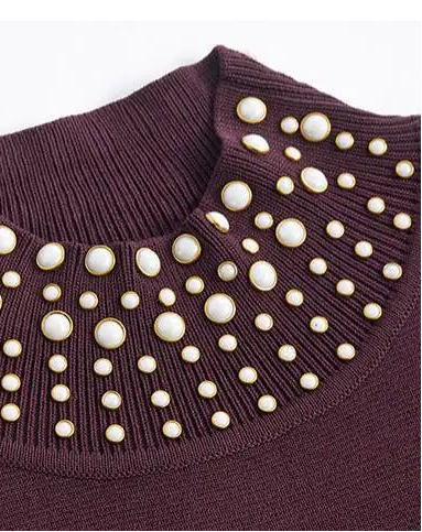 Close-up of a purple sweater with a decorative pearl collar on a white background