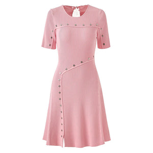 Pink dress with button details on a white background