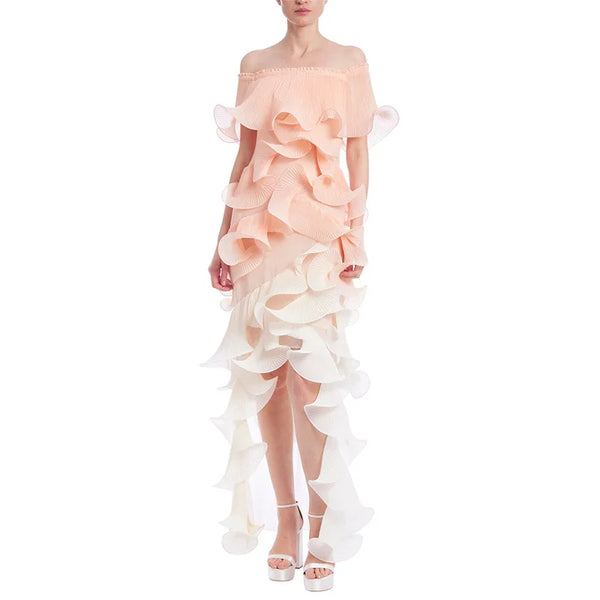 Woman wearing a peach off-shoulder dress with ruffled layers on a white background