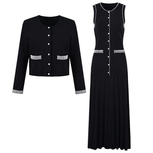 Black jacket and dress set with decorative buttons on a white background