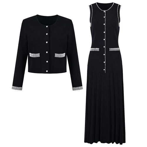 Black jacket and dress set with decorative buttons on a white background